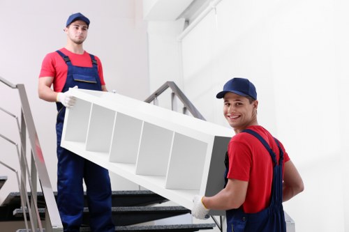 Local movers handling furniture in a Hackney Marshes flat move