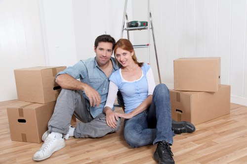 Professional movers handling furniture in a local East London flat