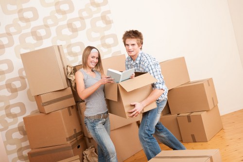 Local movers handling furniture in an East London property