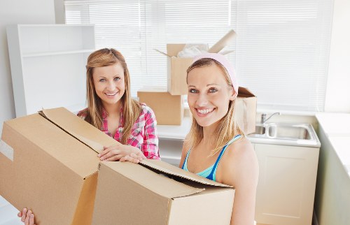 Local movers carrying furniture near Hackney Marshes homes