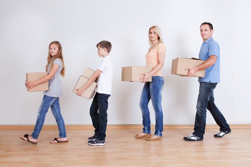 Removal team assisting with boxes and furniture in East London